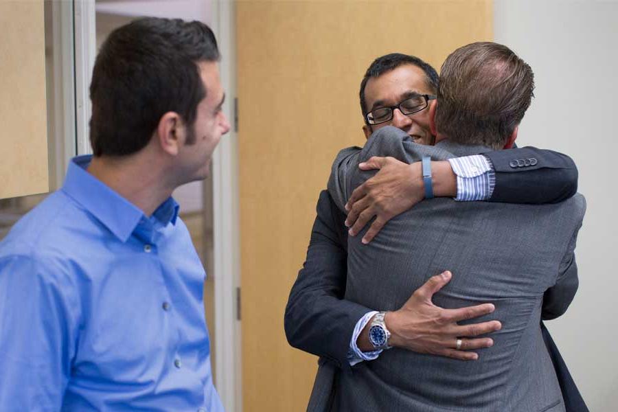 Parboteeah hugs doctoral candidate Stephen Gray.